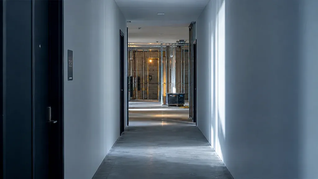 Long apartment corridor with smooth finished drywall